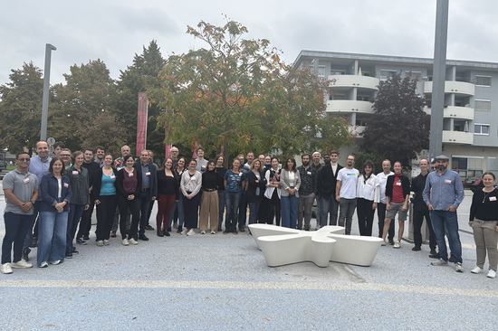 The photo shows about 40 people standing in a semi-circle.