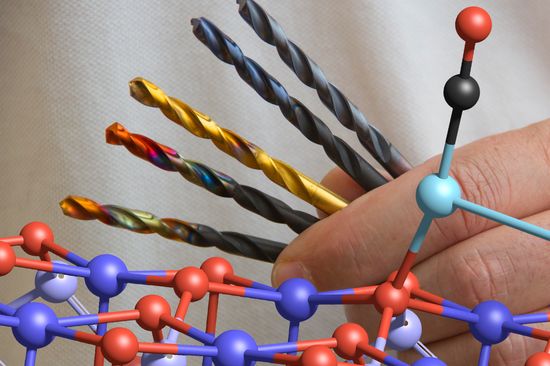 Symbolbild - eine Hand hält bunt gefärbte Bohr-Aufsätze