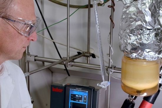 Researcher with beakers during the experiment