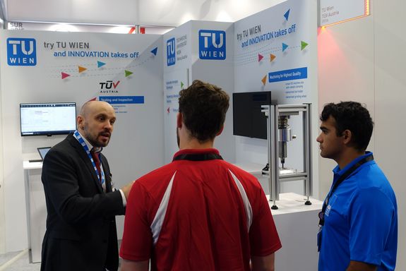 Florian Donner talking to two interested visitors