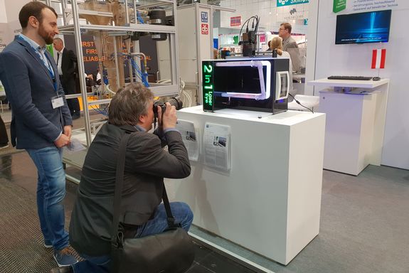 A journalist takes a photo form the 2-in-1-Laser Eye model at the TU Wien stand.