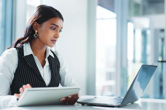 A Women sits in front of a computer