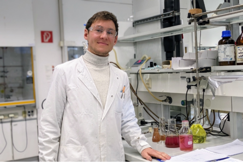 Elias Horn standing in the lab wearing lab coat