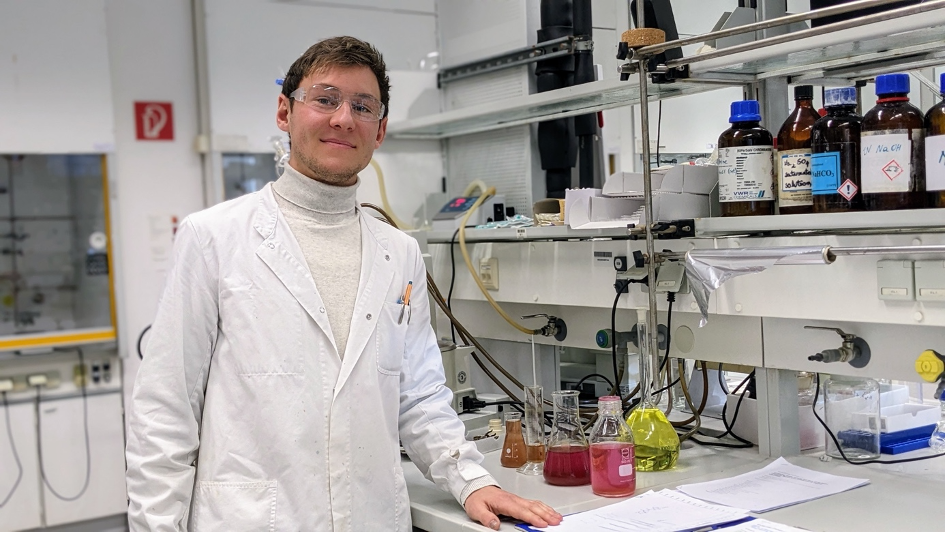 Elias Horn standing in the lab wearing lab coat