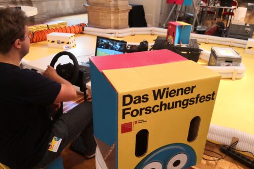 Person sitting at a steering wheel