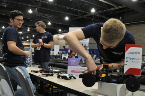 Student checking car hardware components