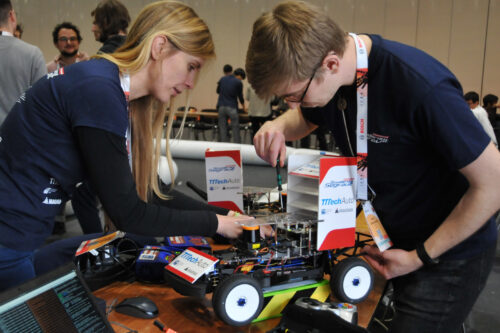 Students working on hardware of race car