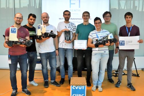 Team of TU Wien after the competition with cars and trophy