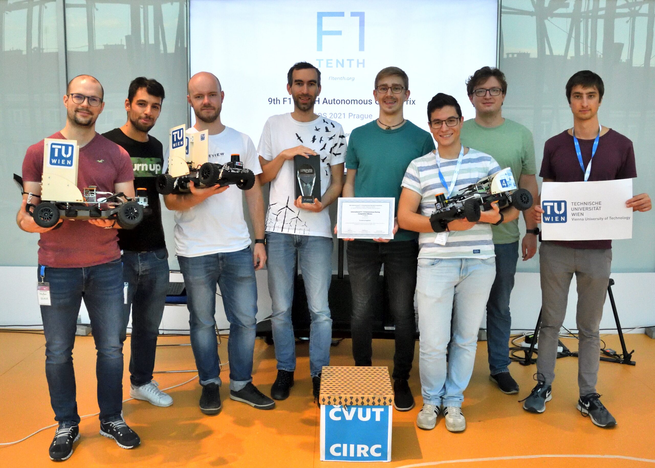 Team of TU Wien after the competition with cars and trophy