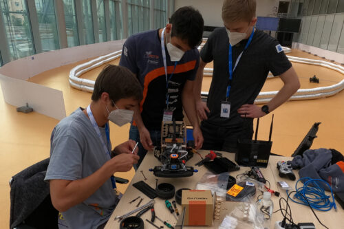 Students replacing tyres of the racing car