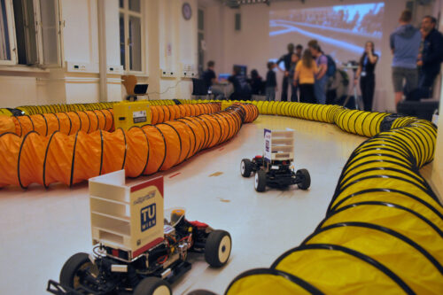 Two model race cars on the demonstration track