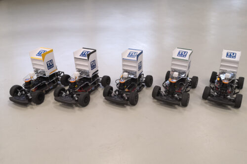 Five race car based on model Fiesta standing on the floor