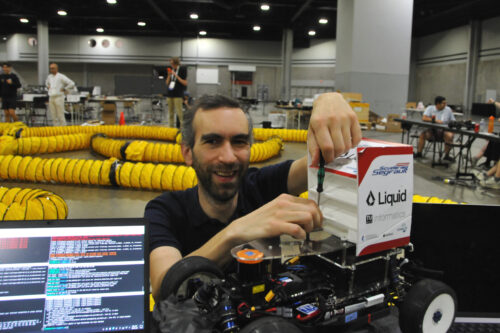 Team members are preparing the model race car