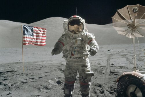 Astronaut am Mond neben der amerikanischen Flagge